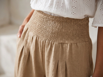 Smocked wide-leg linen trousers - close-up fabric detail